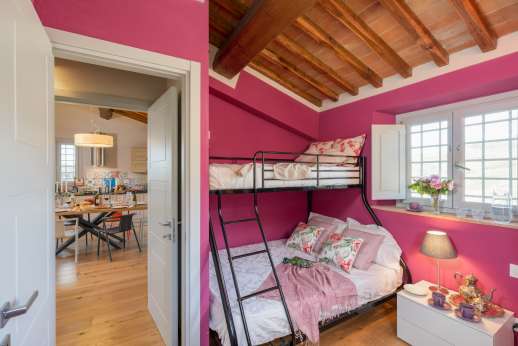 Maggiano Piccolo - To one side of the kitchen, a door leads to one bedroom with a queen-size bunk bed