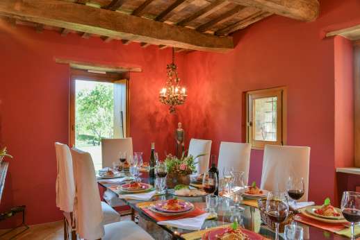 Tra Sanvento - a glass door leads from a shaded portico into an airy, open-plan living and dining area