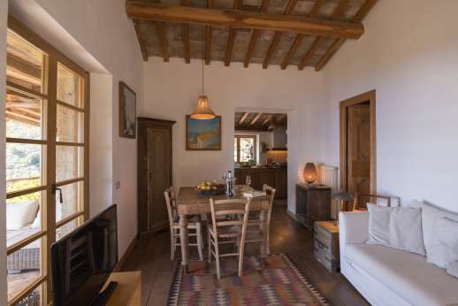 Spini Bianchi - Open plan, well equipped kitchen and sitting room both leading out to a terracotta terrace with a pergola.