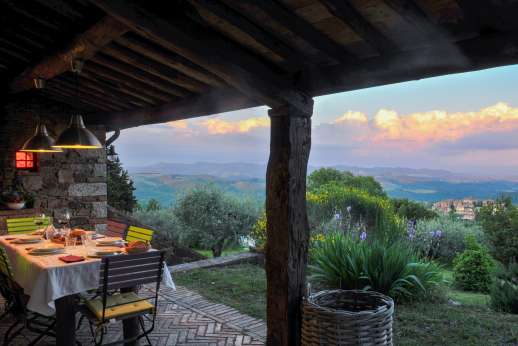 Villa Cignano - The loggia with open fire and view of the pool.