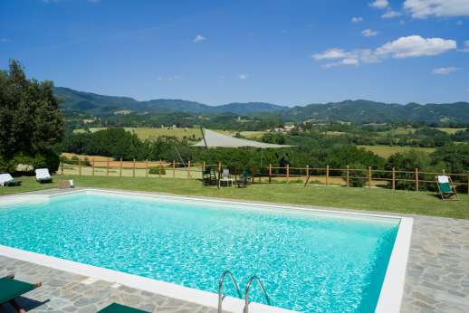 Weddings at Villa Atena - The dining pergola set on the terrace overlooking the Casentino countryside.