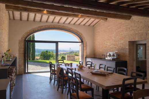 PodereSole - A glass door leads from the outside area into a grand dining room