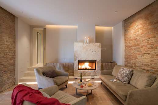 PodereSole - The living area with a travertine fireplace