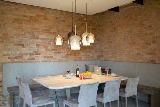 PodereSole - Living area and minimalist dining area with a table for 10
