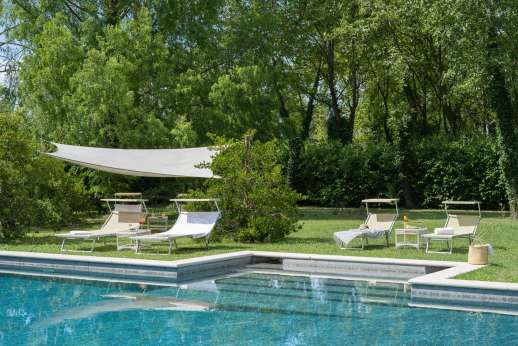 Villa Michiel - A path leads through a gate and crosses a tiny stream to reach the beautiful fenced pool.