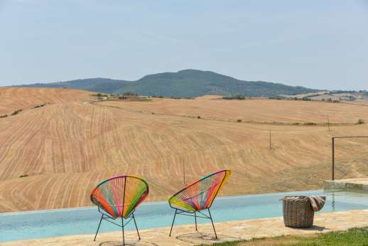 Poggiobuono - The private infinity edge swimming pool is set on the edge of the garden enjoying the best of the views with two terraces for sunbathing furnished with quality loungers