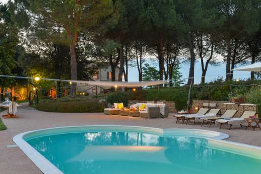 Weddings at Villa Ostignano - The pool and seating area is lit and can be enjoyed at night