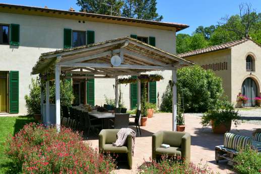 Villa D'Elsa - A pergola sits in front of the villa furnished for al fresco dining with a barbecue and views of the surrounding countryside.