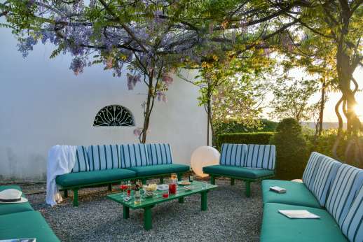 Villa Caprolo - Outdoor seating by the dining area and by the chapel