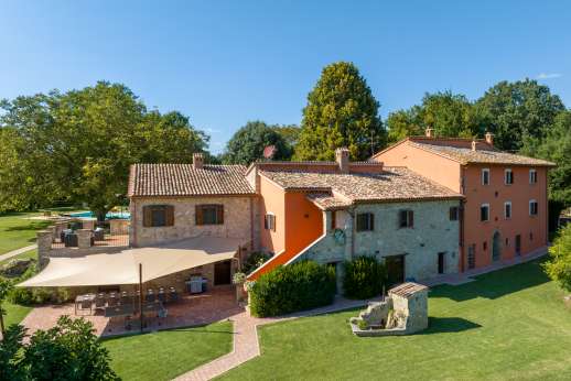 Solomonio - Main kitchen and pantry lead out to a shaded terrace with a large dining table for 18 and an internal staircase up to the summer dining room.