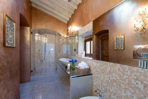 Villa Di Masseto - One of the stylish bathrooms with shower and elegantly mosaicked walls.