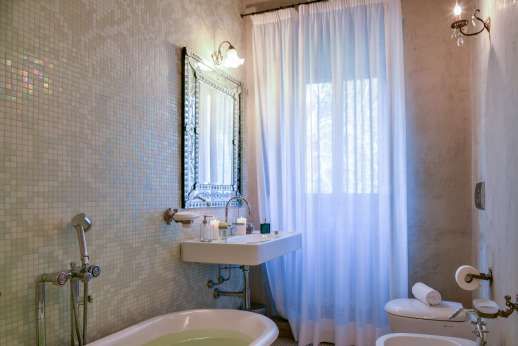 Villa Di Masseto - Bathroom with bath and beautiful white mosaics.
