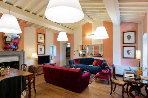 I Giullari - East wing first floor, air conditioned open plan sitting/dining room with fireplace.