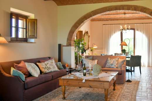 Dadianora - Spacious living room composed of a seating area with 3 sofas, a large table, a wood-burning fireplace and a small library