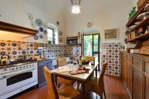 Villa San Martin - Kitchen both leading out to the courtyard with a loggia furnished for al fresco meals