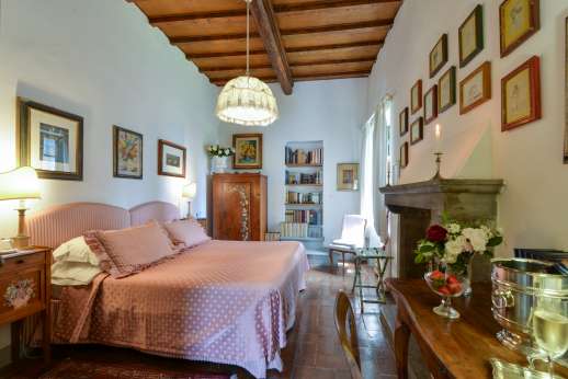 Villa San Martin - Double bedroom [convertible to twin] with a decorative fireplace. Bathroom with shower.