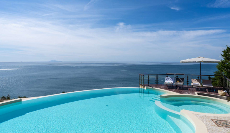 Infinity pool at Castello di Punta Ala overlooking the Tuscan coastline and Tyrrhenian Sea.