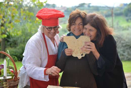 Guests enjoying a traditional Italian cooking experience in the Umbrian countryside