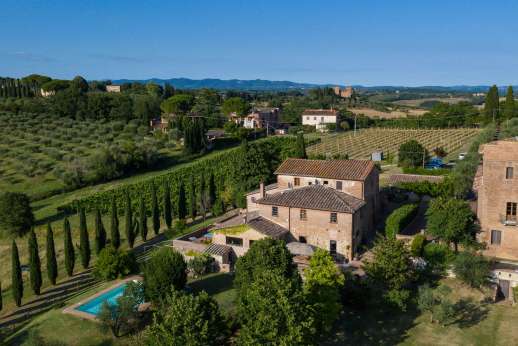 Villa Santa Dieci in the Tuscan countryside near Siena surrounded by vineyards and olive groves, location for organic wine tasting experience