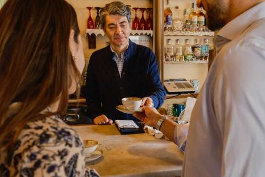 Local guide serving coffee to guests during a private Florence food tour