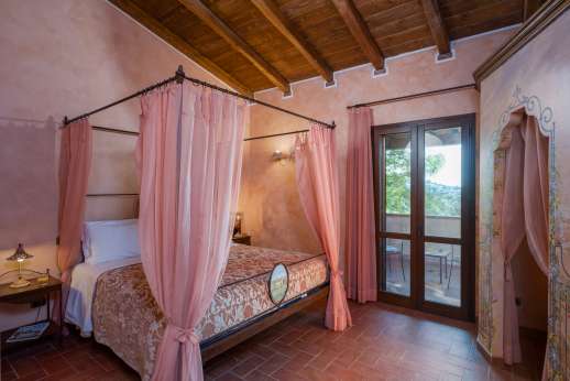 Il Chiesino - The first floor air conditioned double bedroom, with doors out to the terrace.